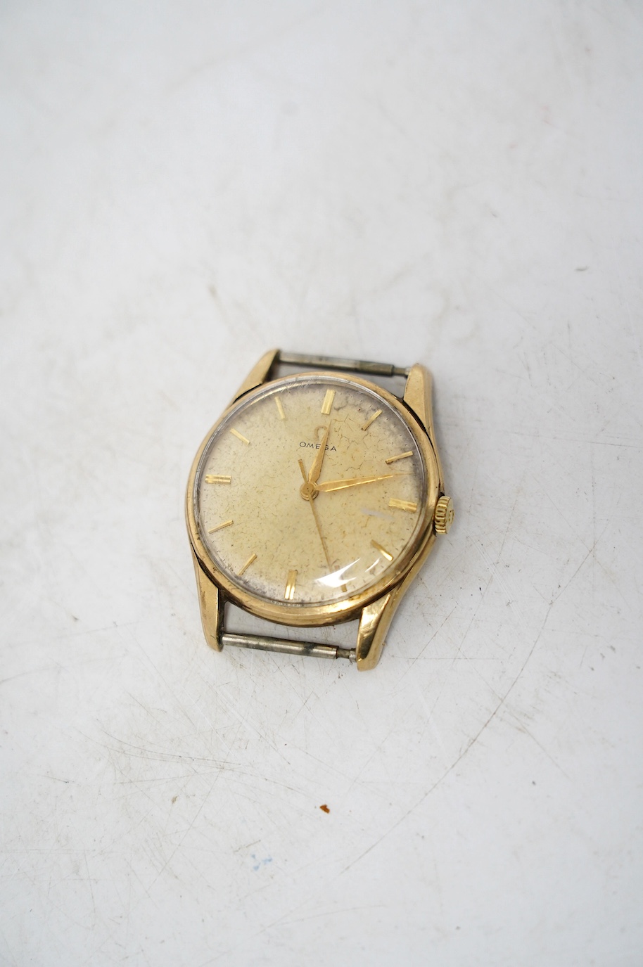 A gentleman's 9ct gold Omega manual wind wrist watch, no strap, case diameter 34mm, with Omega box. Condition - poor